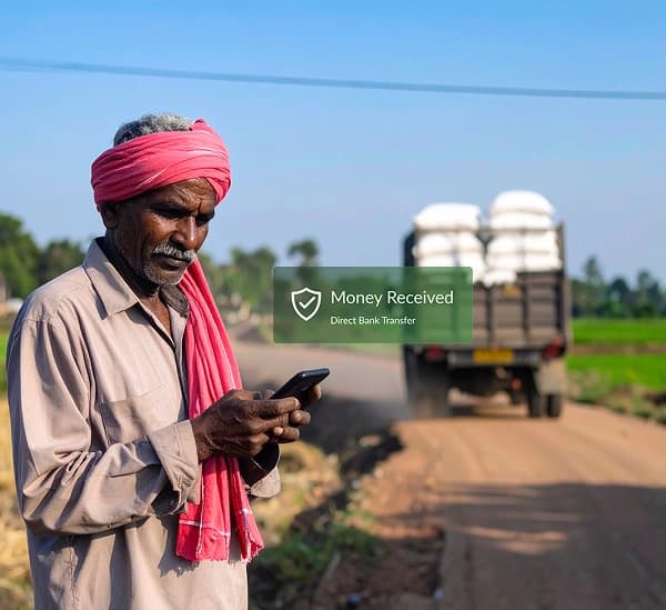 Farmer using mobile phone in field with notification overlay